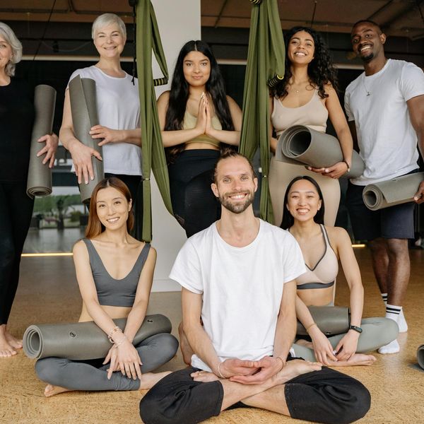 Group of people smiling after a yoga class.
