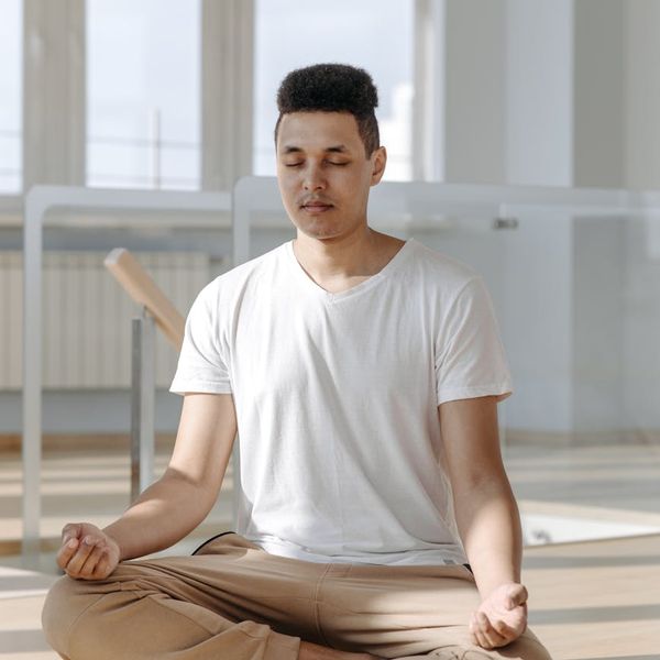 Person meditating peacefully in a bright, clean environment.